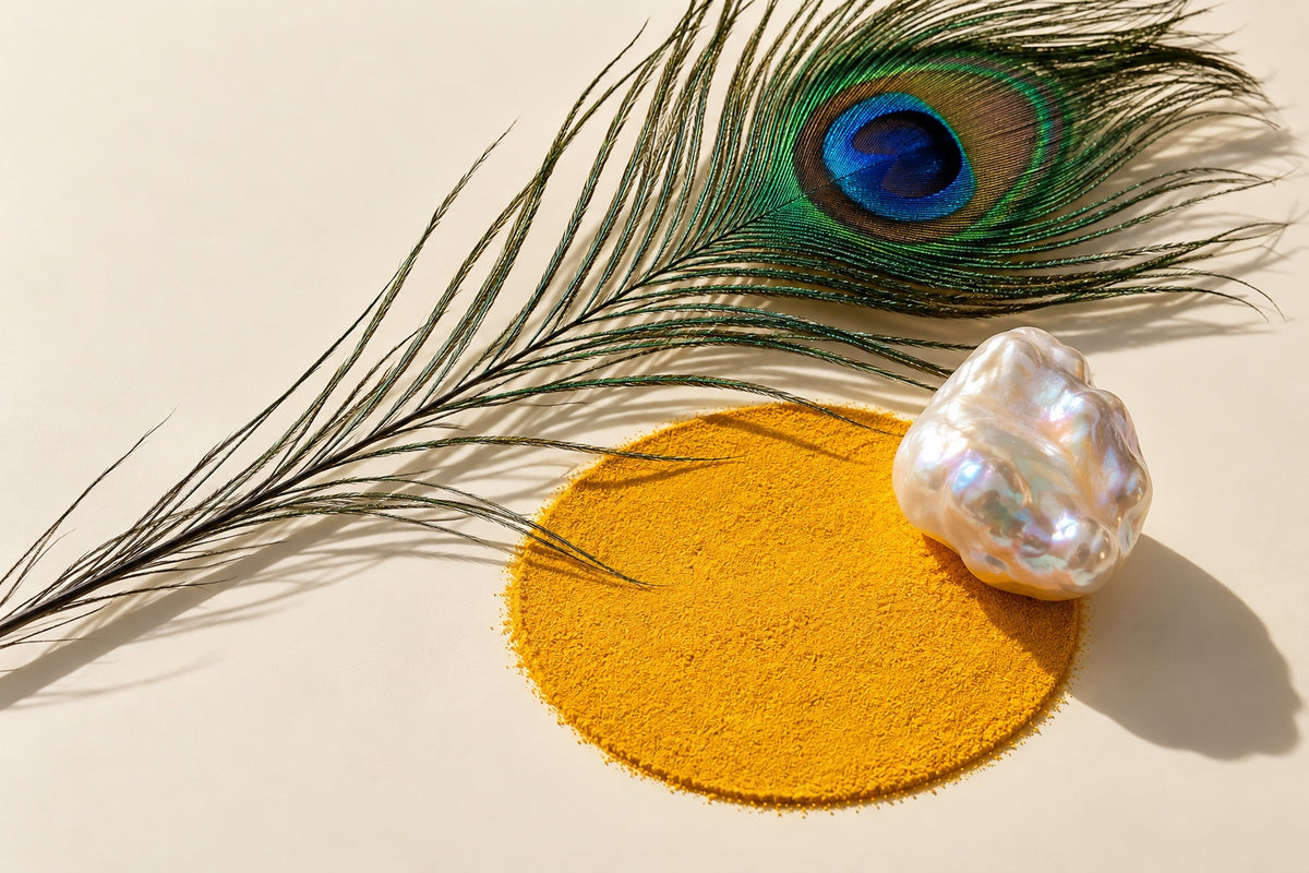 Concept material study: a pearl, haldi pigment and peacock feather