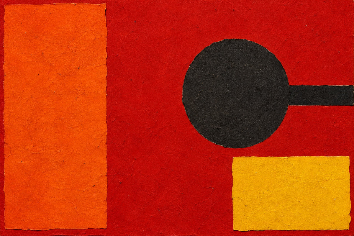 Abstract concept study of vermilion pigment, orange and yellow paper, and a charcoal circular form