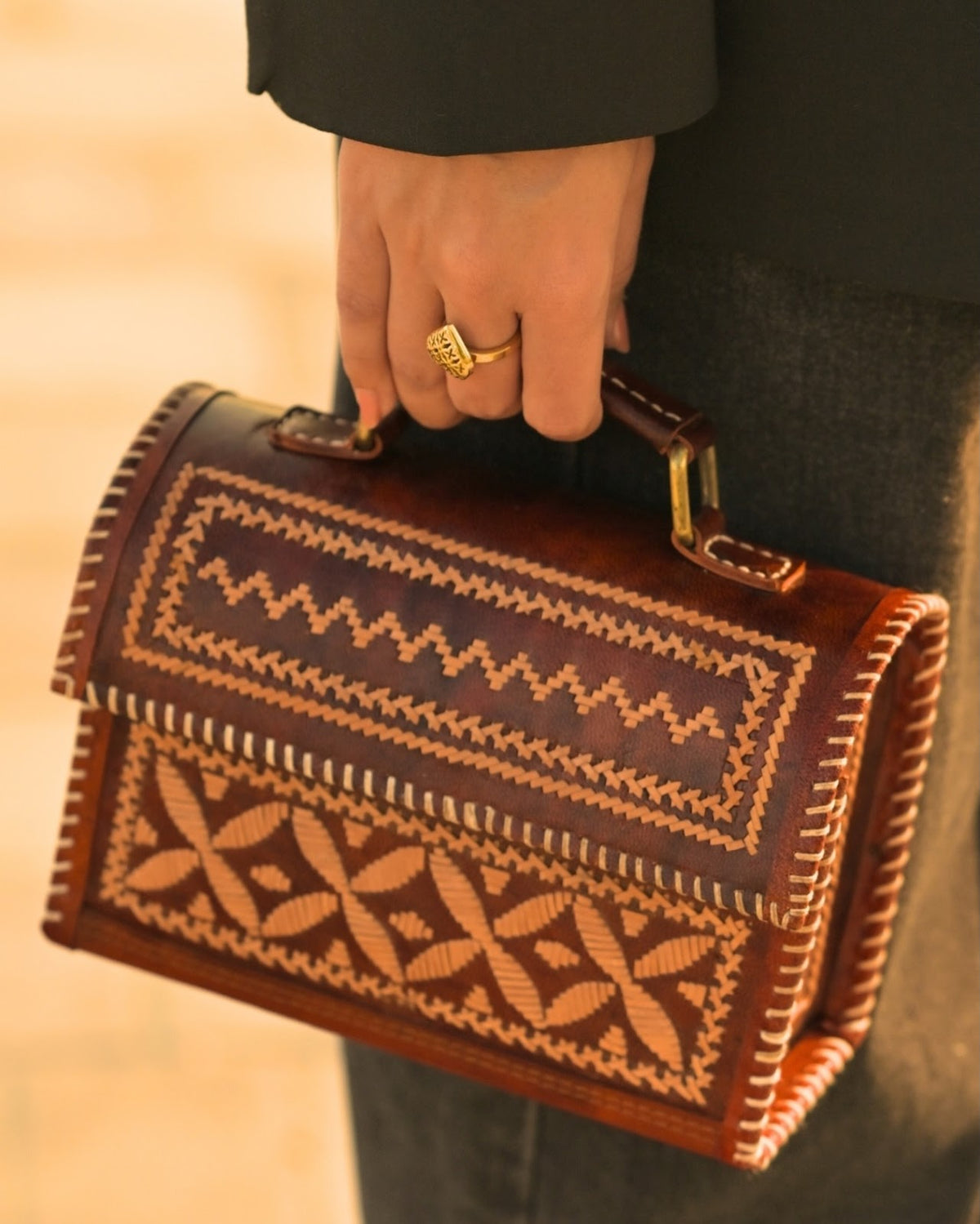 Detail of brown leather and geometric pale lacing